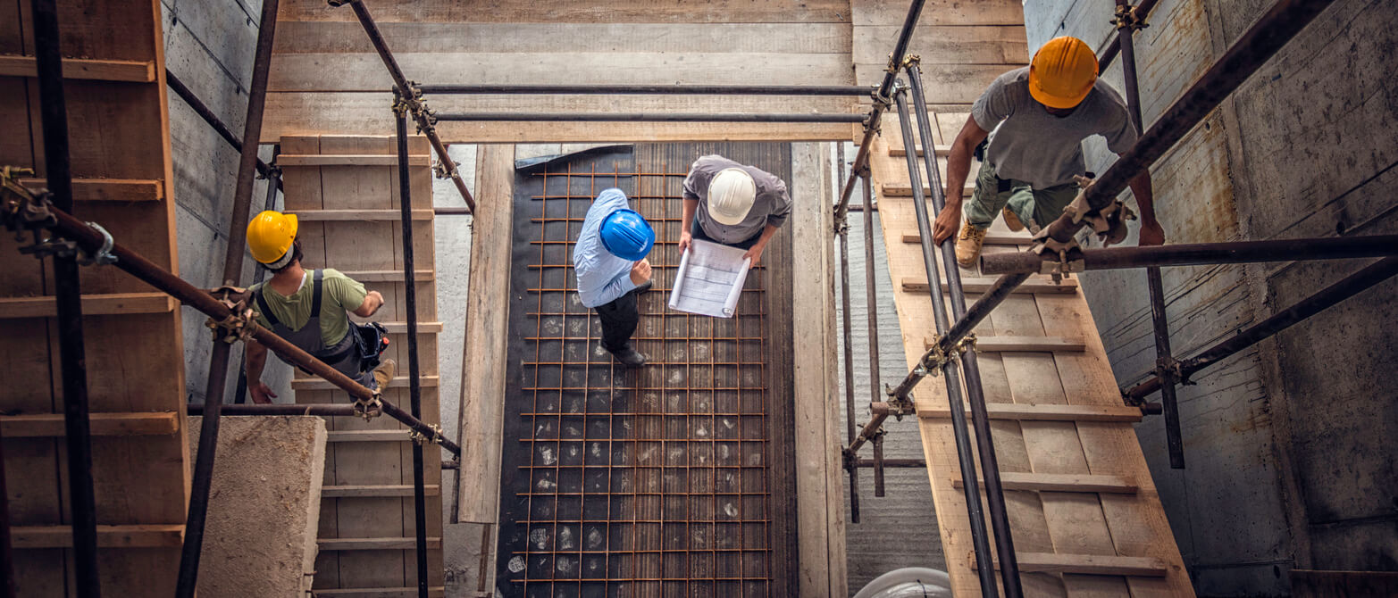 Construction workers and an architect viewed from above