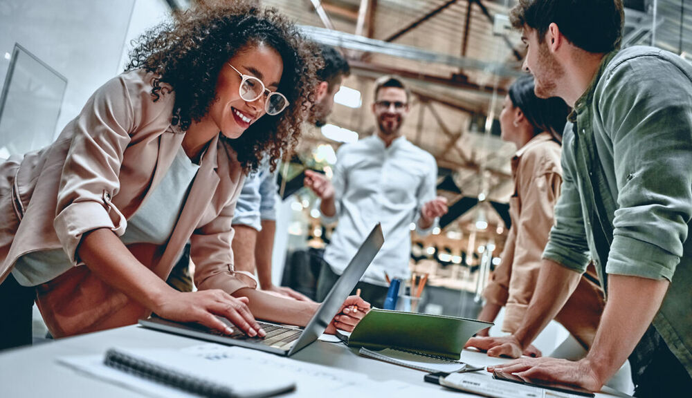people leaning over a table during a meeting