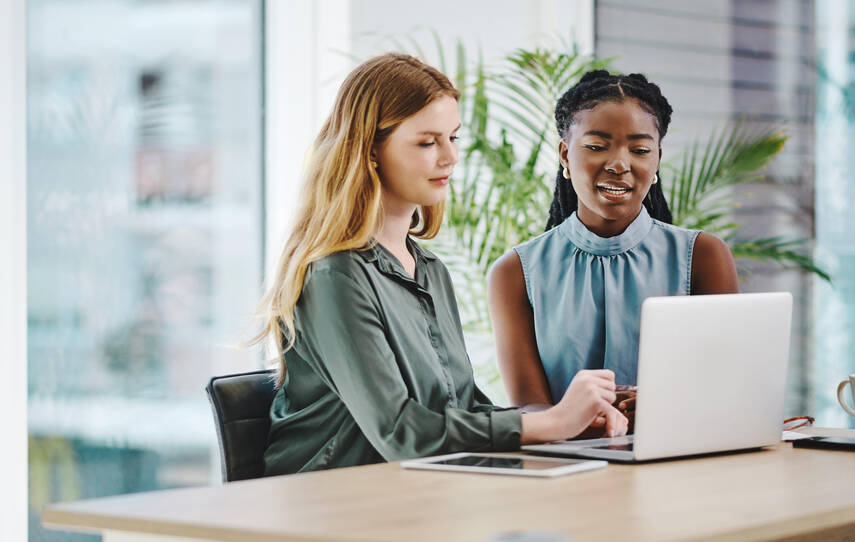 Two people looking at a laptop