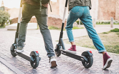 two people on e scooters