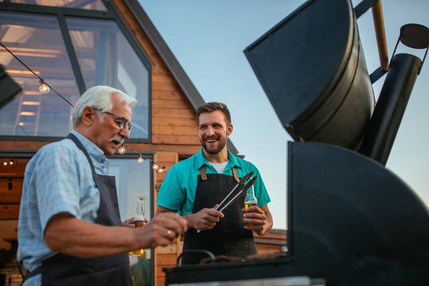 Father and son in front of a bbq