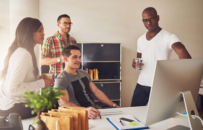 People gathered around a computer