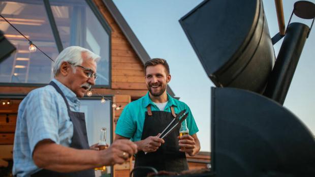 Father and son in front of a bbq
