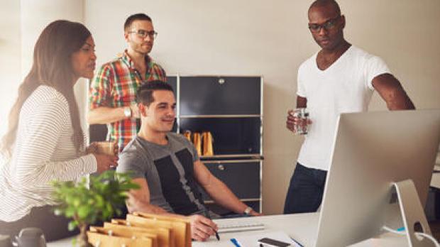 People gathered around a computer